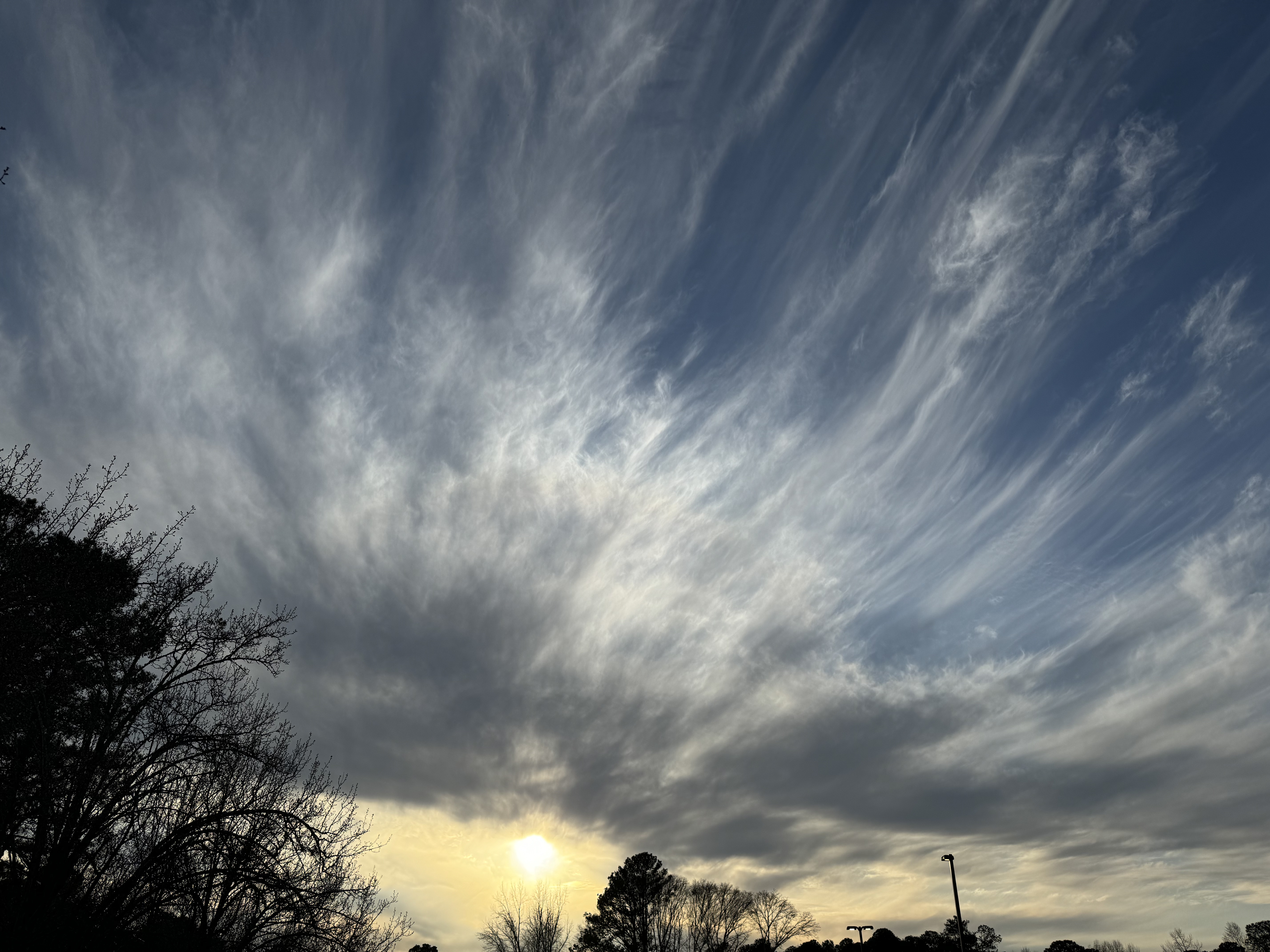 Landscape photo of stringy cirrus clouds near sunset.
