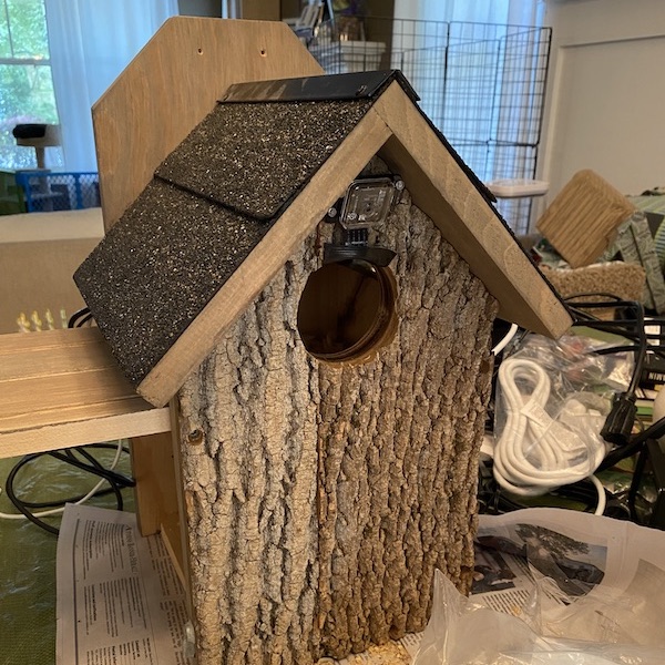 A birdhouse sized for small owls, being retrofitted to house a single Raspberry Pi 3B+ connected to multiple cameras positioned discreetly on the outside of the birdhouse, while still providing room inside for birds to nest.