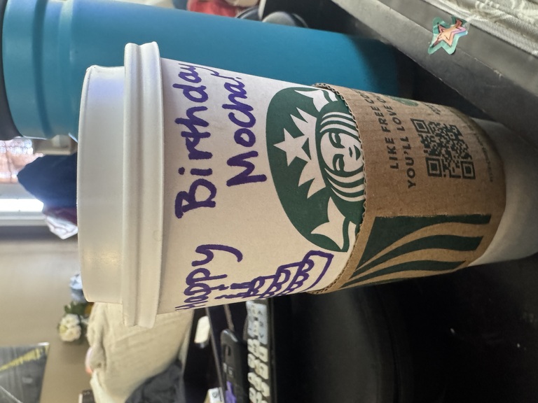 A Starbucks mocha marked up with 'happy birthday' messages.